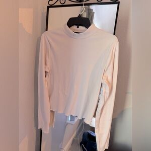Cream/beige turtleneck crop top with lettuce trim